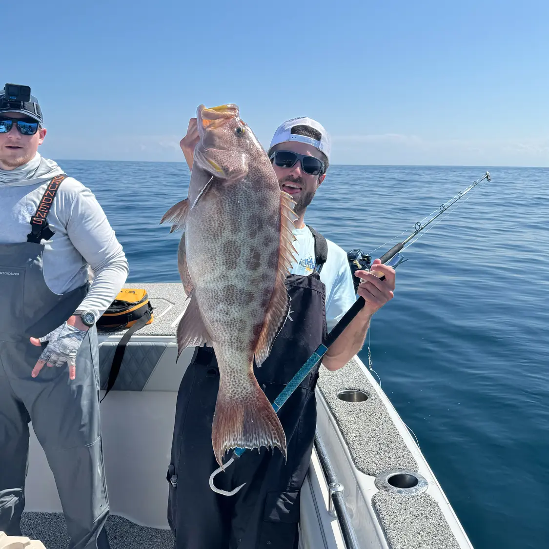 Angler holding a nice grouper caught on a bottom fishing trip with Finatical Charters in Destin, Florida.